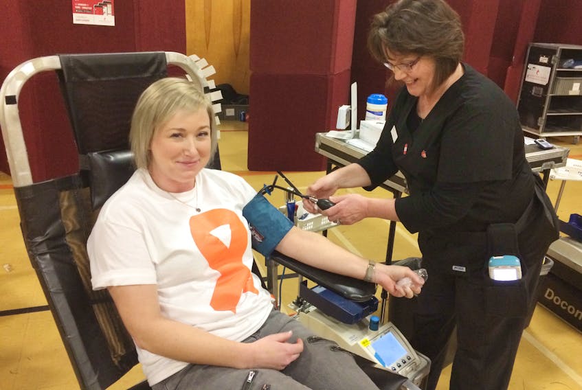 Donor Care Associate Charlene McCracken helps prepare Kristi Chisholm for donating blood. Chisholm donated in honour of her nephew Brayden Ross, who is battling cancer.