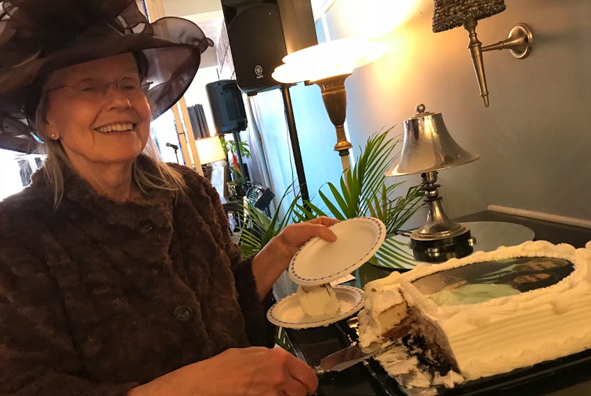 Host Sandy Guadagni serves a commemorative cake to guests at 135 Provost Street on May 19.