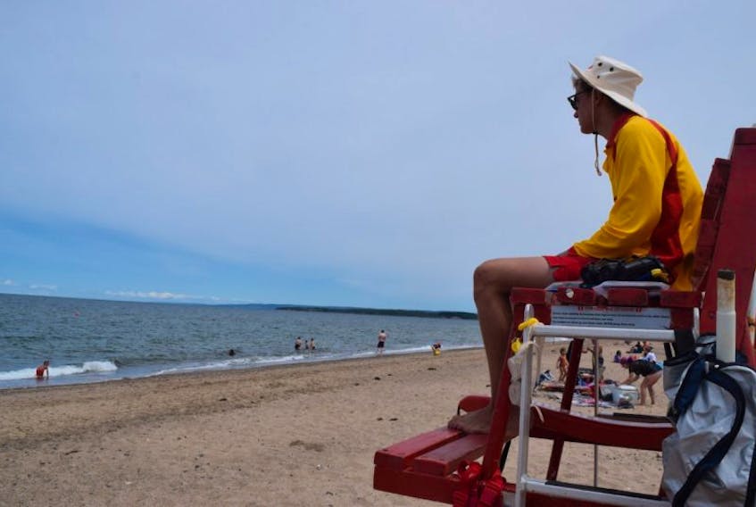 Dean Sangster with the Nova Scotia Lifeguard Service watches the waters at Melmerby Beach on Monday.