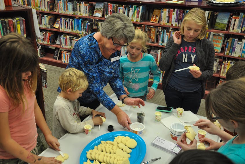 Leslie Chapman, a library clerk at the Stellarton library, leads an activity in which young guests made a number of Halloween cookies.