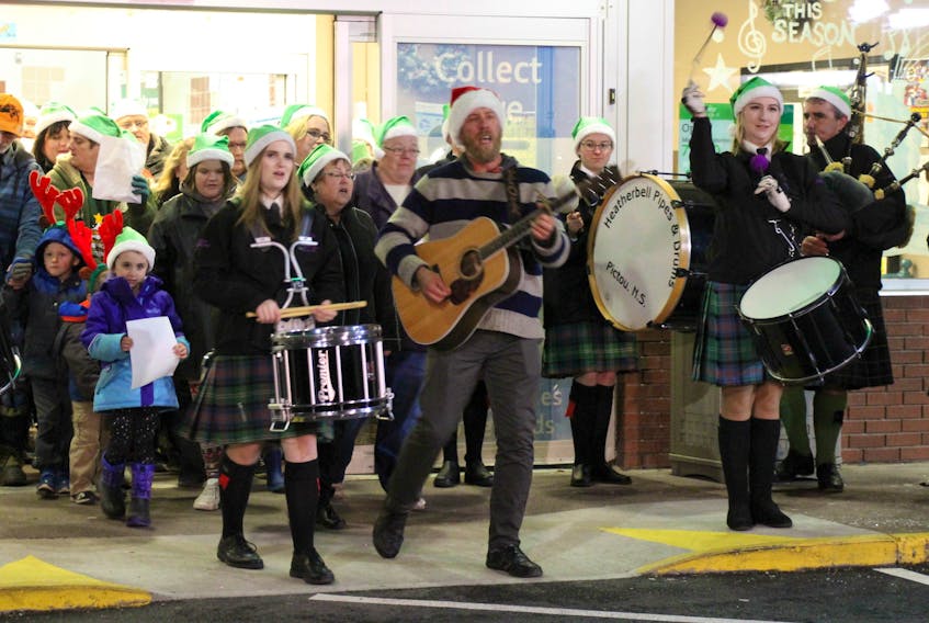 Local musician Albert Dunnewold, right, and Elizabeth Sharpe of the Heatherbell Pipes and Drums lead the way during a video shoot for the Star of Christmas in-store contest being held across Atlantic Canada for Sobeys. The store with the most votes will be awarded $5,000 for a community organization of its choice.