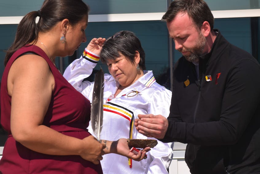 Tonya Francis performed a smudging ceremony prior to the flag raising. Pictured with her are Chief Paul and Jim Pomeroy, CEO of the Pictou County YMCA.