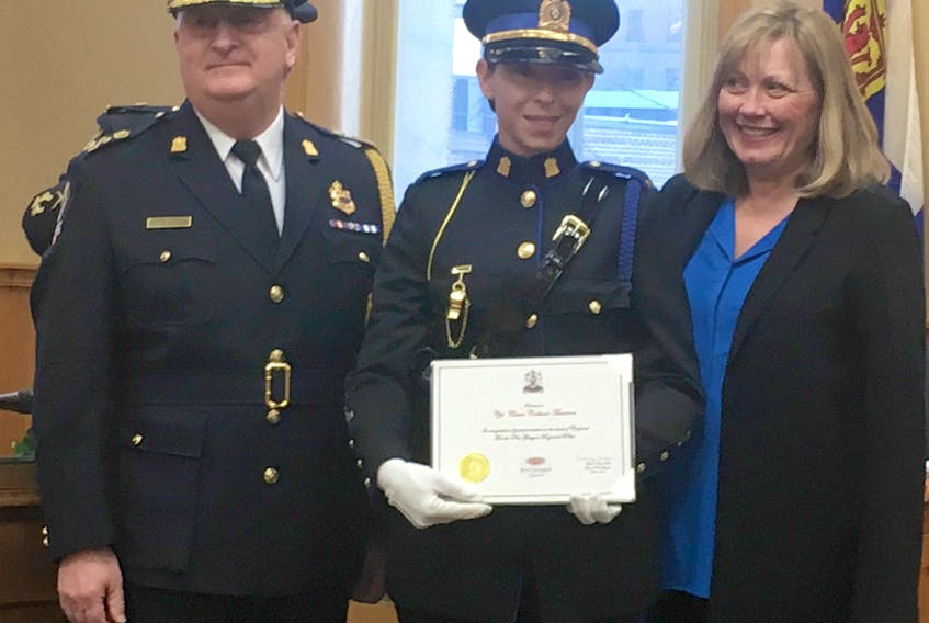 Claire Corkum-Timmons became the first female officer promoted to the rank of corporal. Presenting her with the promotion are Police Chief Eric MacNeil and New Glasgow Mayor Nancy Dicks.