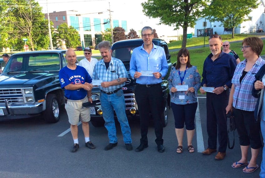 Eric Boudreau, Pictou County Antique Car Club treasurer, presents $500 cheques to: Dave Lees of LORDA, Danny MacGillivray of CHAD Transit, Lisa Smith with Early Childhood, Eric Atkinson of St. Martha’s and Donna Richards with the Children’s Wish Foundation. This weekend the club is holding their annual Show and Shine in New Glasgow.