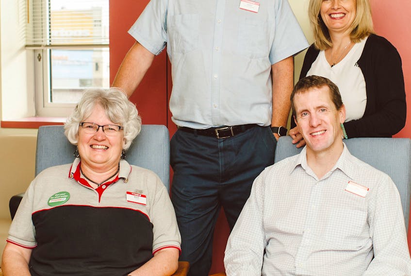 Ron Matlock is pictured seated at right along with members of his team from Shoppers Drug Mart, Marie MacLeod and Derek Smith. Also pictured (standing) is Catherine Daye, RN.