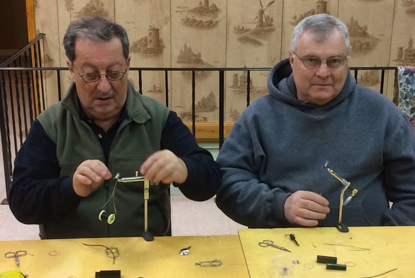 Strachan and Everett MacKay were among the dozen members of the Pictou County Fly Tyers Club busying themselves with the creation of flies for the coming fishing, last Sunday.