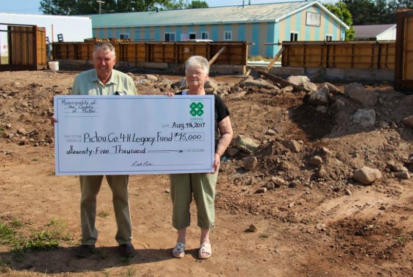 County Warden Robert Parker, left, donates $75,000 to Pictou County 4H on behalf the Municipality of the County to Bonnie Allan of Pictou County 4H. The money goes towards the expansion of the 4H Life Skills barn.