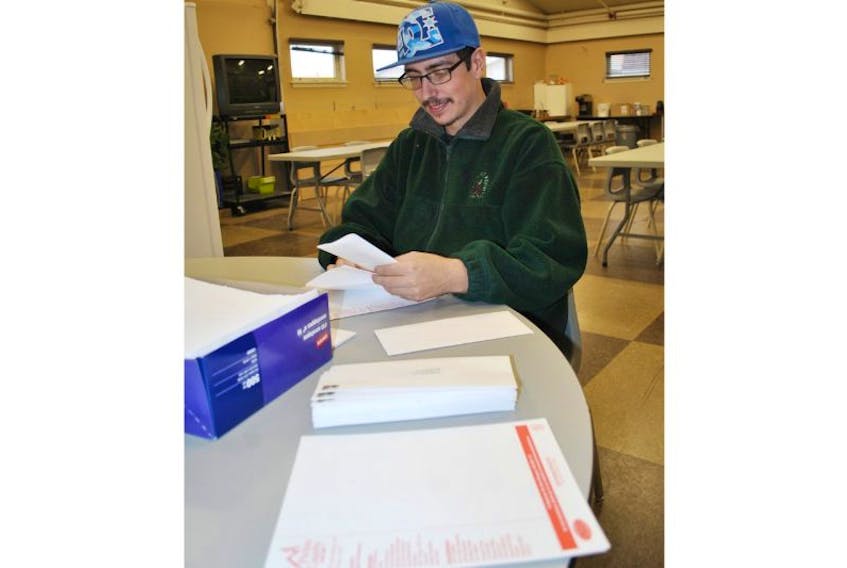 Roy Hingley, a client at Summer Street Industries, stuffs an envelope for the Pictou County Fuel Fund’s annual giving campaign appeal, which is now underway. Hingley was one of 10 SSI clients who helped with getting the PCFF information ready to mail.