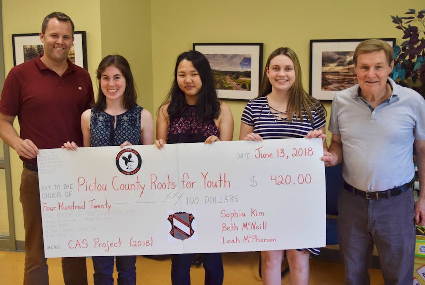 Pictured from left are: NRHS vice principal Andrew Francis, students Beth McNeill, Sophia Kim and Leah McPherson, along with Roots for Youth board member Ken Francis. Ken Francis said it’s heartwarming to see the students take the initiative to help less fortunate youth.