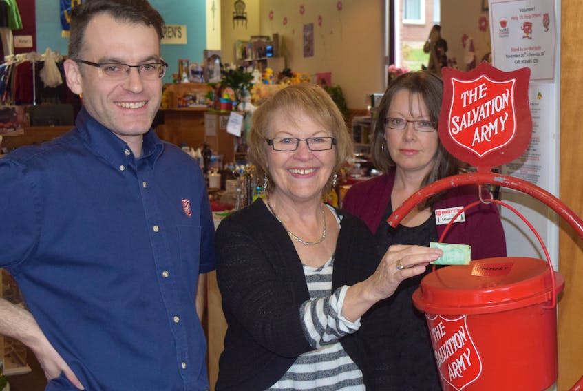 Dion Durdle, Dianne Ring and Wendy Ward, all with the Salvation Army, display one of the many kettles to be set up at businesses around Pictou County.