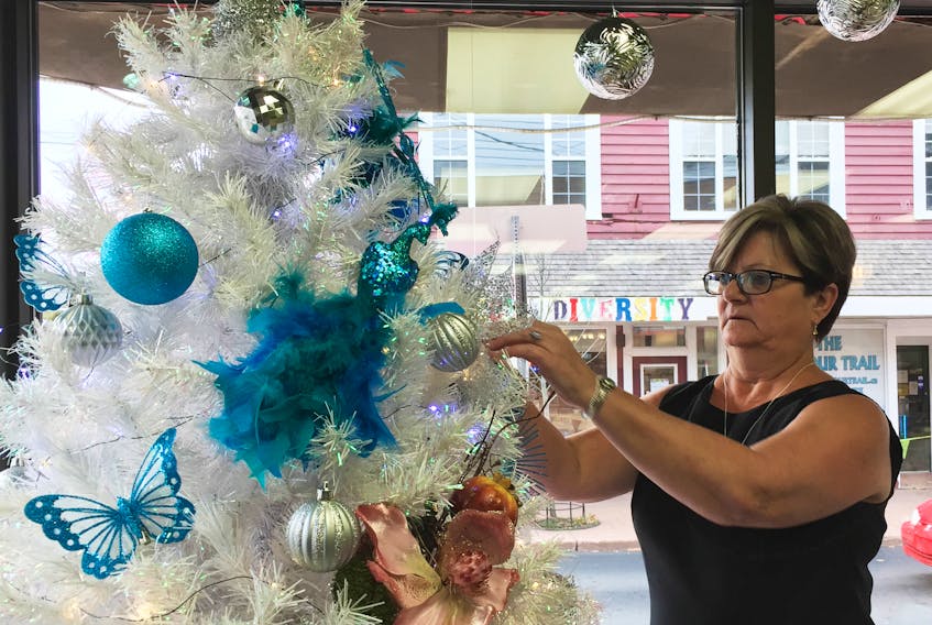 Pam Ford decorates a tree in her downtown business.