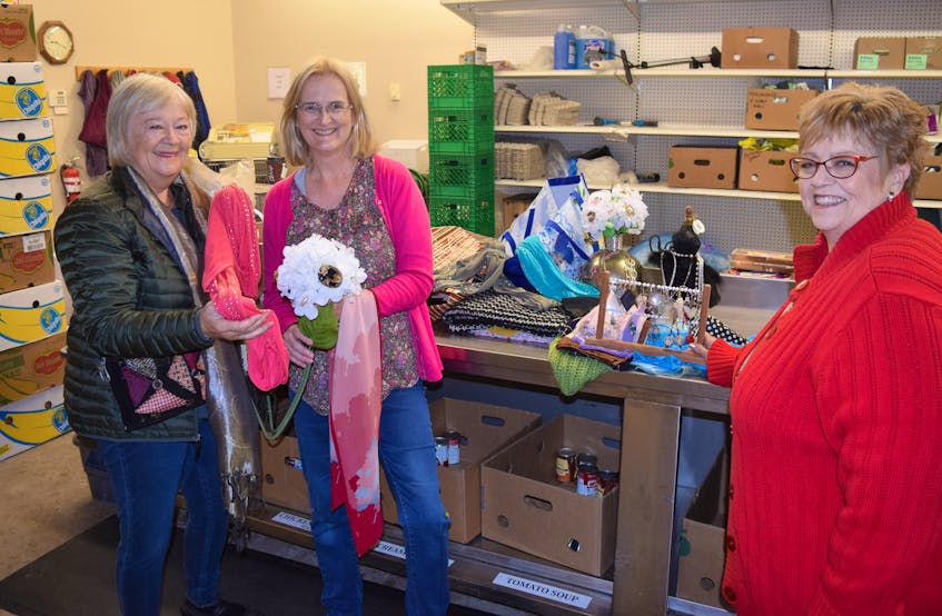Jeanne Coppillie, Carolyn Bygrave and Susan Chickness stand by a collection of some of the jewelry and scarves collected for a sale in support of the Pictou County East Food Bank in New Glasgow.