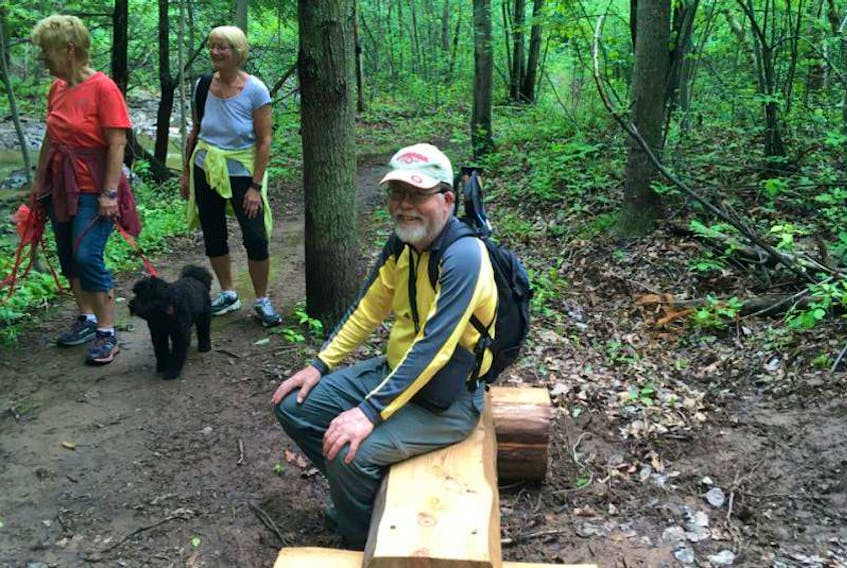 Ken Fraser from the Cape-to-Cape trail sits on one of the new benches in Trenton along the Trenton portion of The Great Trail.