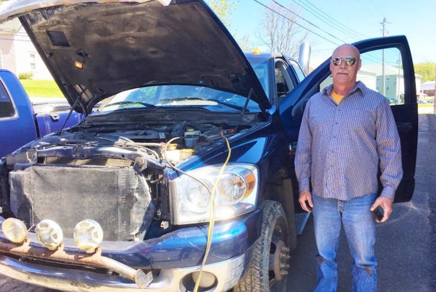 Norman Robson stands beside his truck, which was stolen and damaged on May 26. The accused was in court on Tuesday and entered a guilty plea.