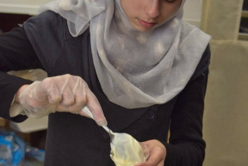 Manar Almetheb, a New Glasgow local originally from Daraa, Syria, prepares food at Culture Days, on Saturday. 