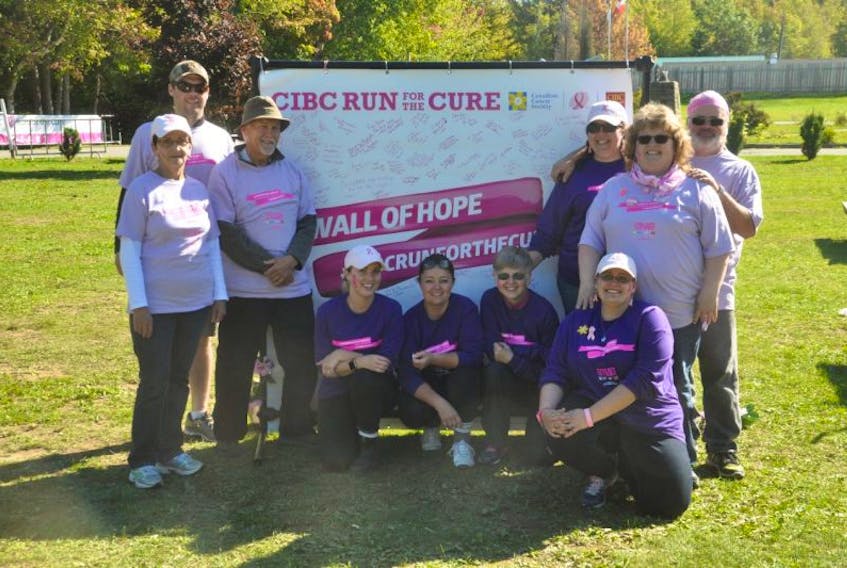 Volunteers (pink) and directors (purple) with the Canadian Cancer Society CIBC Run for the Cure took time from their work organizing Sunday’s run to pose for a photo in Trenton Park.
