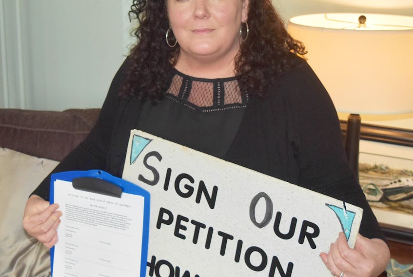 Robbie Weatherbee of New Glasgow, holds a copy of a the petition calling for an inquiry into the hiring practices of the Nova Scotia Health Authority for mental health and addiction services.