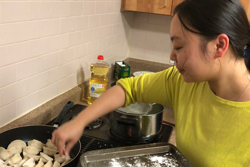 Lin Wu about to fry dumplings for Chinese New Year at the North End Rec Centre on Friday.