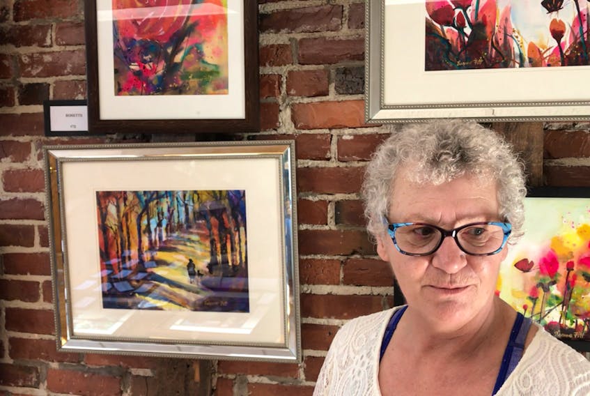 Joanne Keating Fitt, with an assortment of her watercolour paintings, during the Art At Night art festival on Saturday.