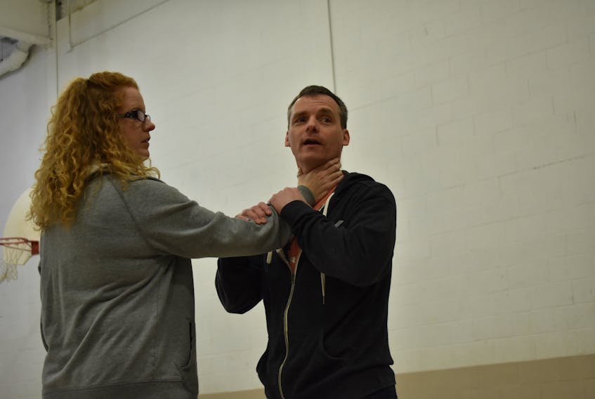 Kelli Cruikshank and her husband Chris demonstrate how to break out of a chokehold during the women’s self-defence class at Pictou Academy.