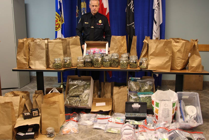 Const. Ken MacDonald with the New Glasgow Regional Police stands with cannabis marijuana, cannabis resin and other items seized following the execution of a search warrant by Pictou County Integrated Street Crime Enforcement Unit Monday at 559 East River Rd.