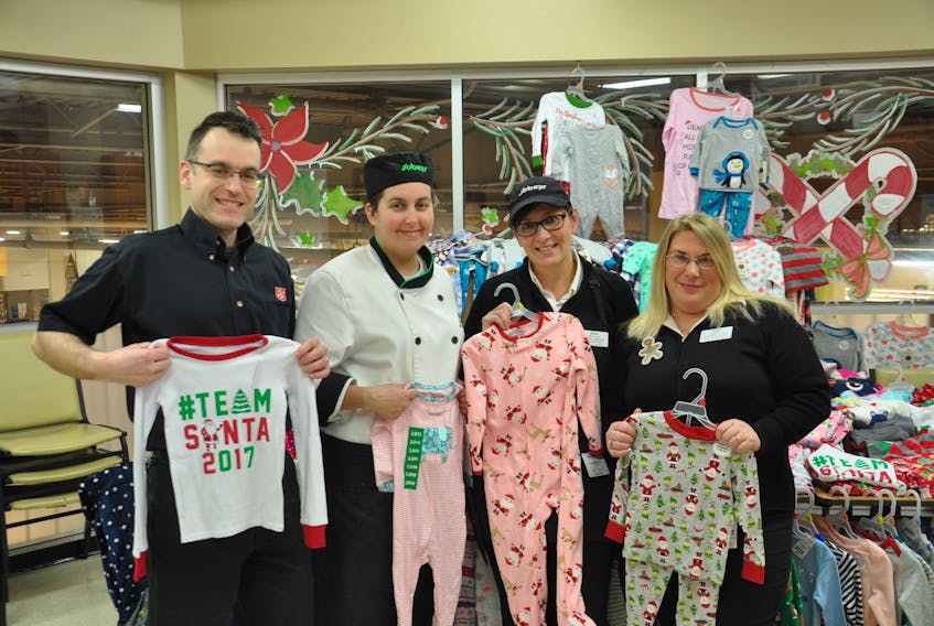 Dion Durdle with the Pictou County Salvation Army, Courtney MacDonald, Lynn Larsen and Heather Cooley with Sobeys proudly display some of the more than 200 pairs of pyjamas purchased in this year’s Christmas Pyjama Drive.