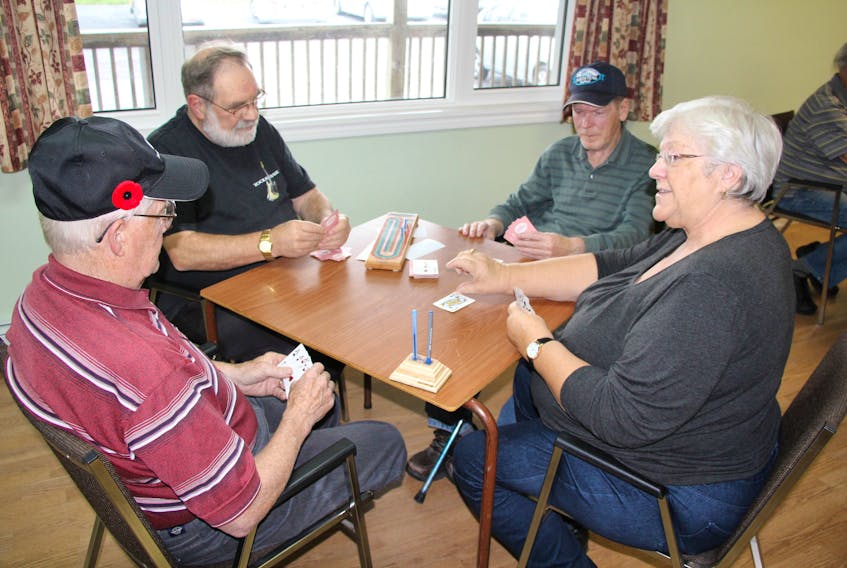 From the left, Gordon Thompson, Jim MacCarthy, Ralph Bennett and Barbara Russell enjoy a game of cribbage at the New Horizons 50+ club in Pictou.