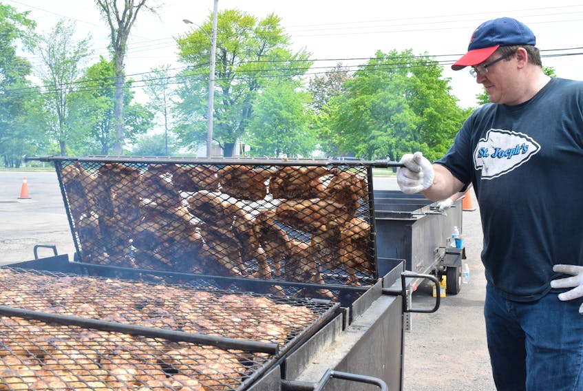 Bernie Murphy flips the chicken over at the Westville Fire Department on Saturday afternoon.