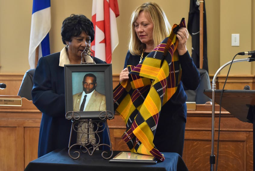 Ruth Paris and New Glasgow Mayor Nancy Dicks unveil a photo of Sparky Paris, who was inducted into the New Glasgow Business Wall of Fame on Oct. 15.
