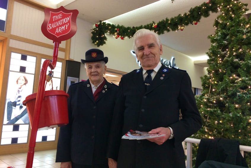 Jenesta, left, and Robert Kathen have been volunteering with the Salvation Army for the past 47 years.  They were manning the red kettle at the Highland Square Mall Thursday in hopes of helping the Salvation Army reach its fund raising goal for 2017. The Red Kettle Campaign wraps up Saturday evening across country.