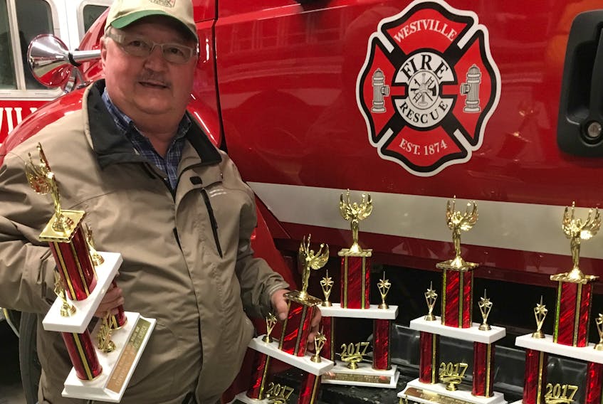 Tom Steele is shown with some of the trophies that will be handed out to this year’s best parade entries. The Westville Fire Department Parade of Lights will be held on Dec. 2.