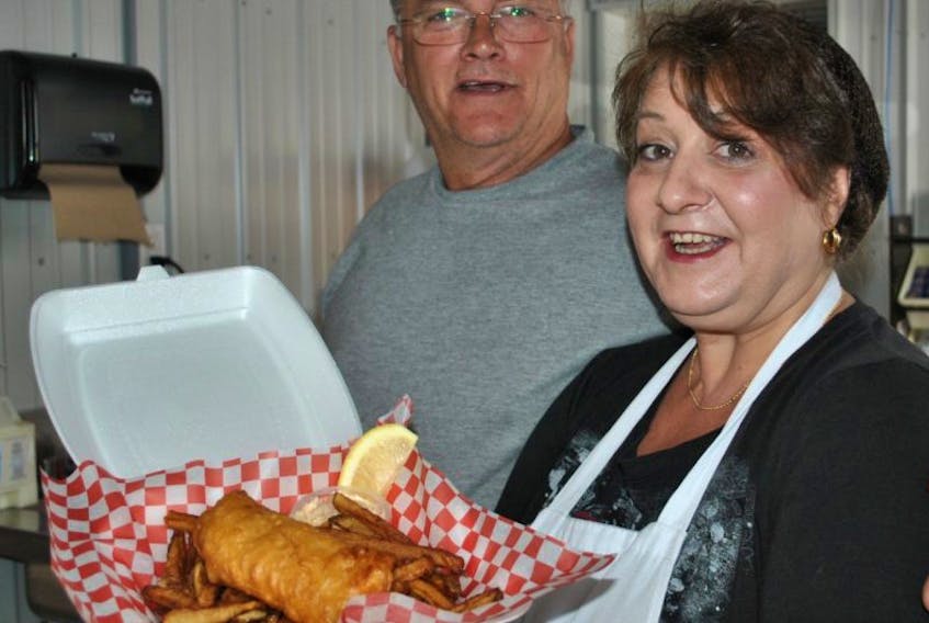 Steeltown Take-out owner Mike MacKenzie and cook Deanie Phalen with fish and chips, one of the offerings at the new restaurant.