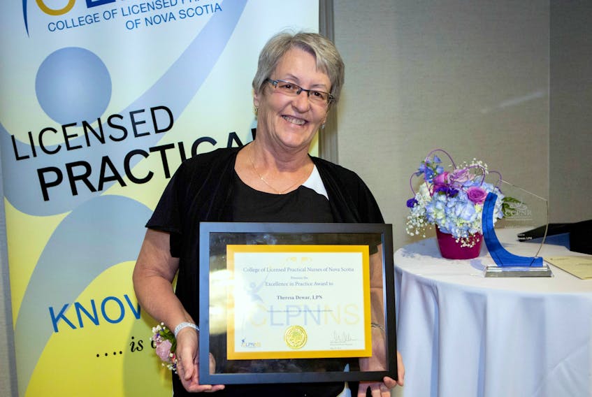 Theresa Dewar, a veteran LPN, at Glen Haven Manor, is pictured as she receives a provincial Award of Excellence from the College of Licenses Practical Nurses of Nova Scotia at the annual awards banquet.