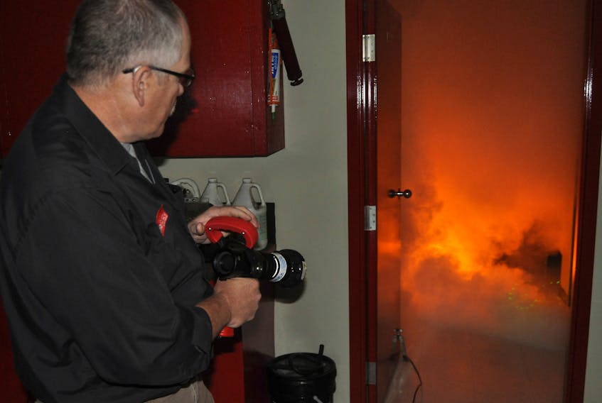 John Dunbar, a sales consultant demonstrates how a BullEx Attack Digital Fire System works in this file photo.