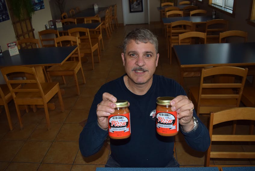 Doug Bonvie with jars of his Pictou County Pizza sauce.
