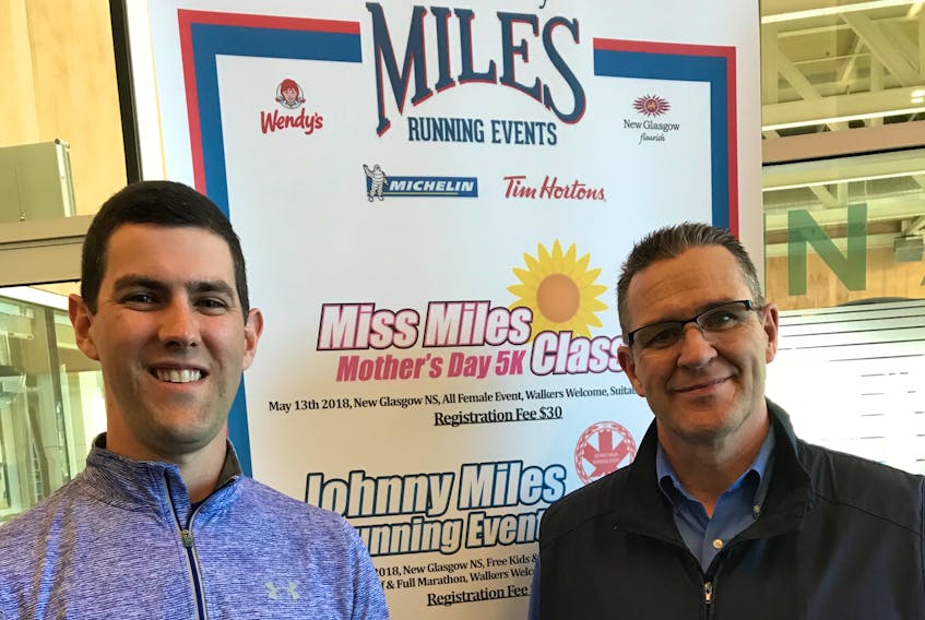 Dr. Brad MacDougall and Johnny Miles director Terry Curley pictured at the Pictou County Wellness Centre in front of a race banner on Friday.