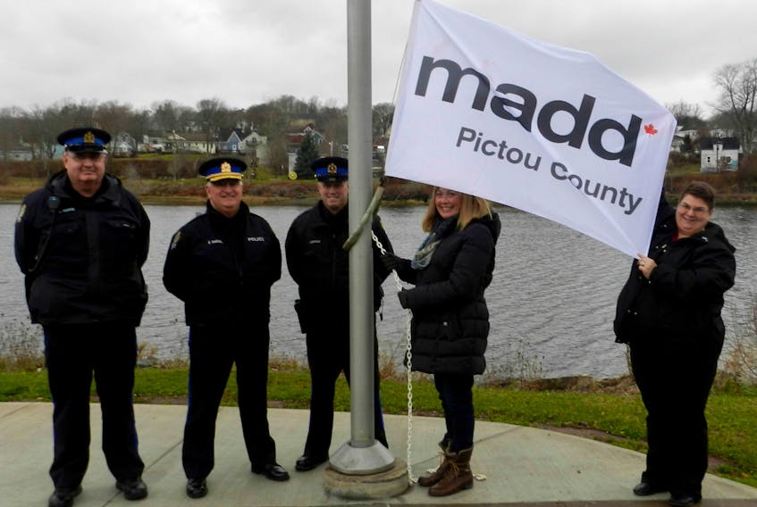 New Glasgow Mayor Nancy Dicks along with Police Chief Eric MacNeil, Const. Ken MacDonald, Const. Graham Purvis and MADD Pictou County Chapter President Joy Polley raise the MADD Pictou County flag at Glasgow Square. From Nov. 1 to Jan. 8, MADD Canada Chapters and Community Leaders will distribute millions of ribbons to Canadians to wear and display as a reminder to never drive impaired or ride with an impaired driver. Red ribbons and car decals are available at Shenanigans Pub and Eatery, Swallows Service Centre, Big Al's Convenience Store & Trophies, Sharpe's Service Station, The LBR, Pictou County Pizza, Mike's Harbour Beach Market, Pictou Landing Ultramar, Wonder Auto and from MADD PC Chapter. Donations to MADD Pictou County can be made through paypal at http://maddchapters.ca/pictoucounty/giving/.