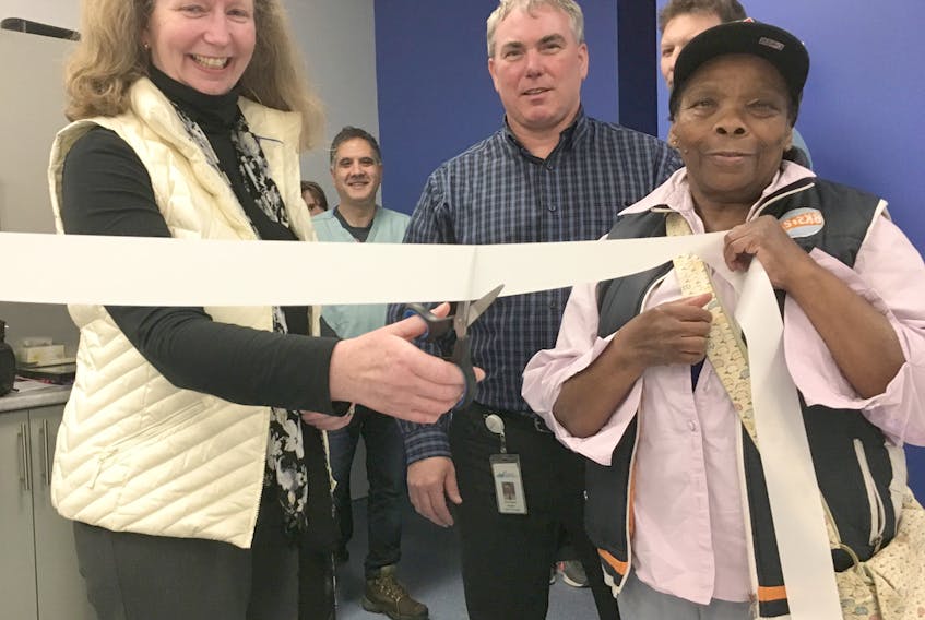 Robyn Eaton, incoming chairperson of the Aberdeen Health Foundation, cuts the ribbon to mark the opening of a new X-ray room at the Aberdeen Hospital. Also shown are Betty Springer and David Quann.