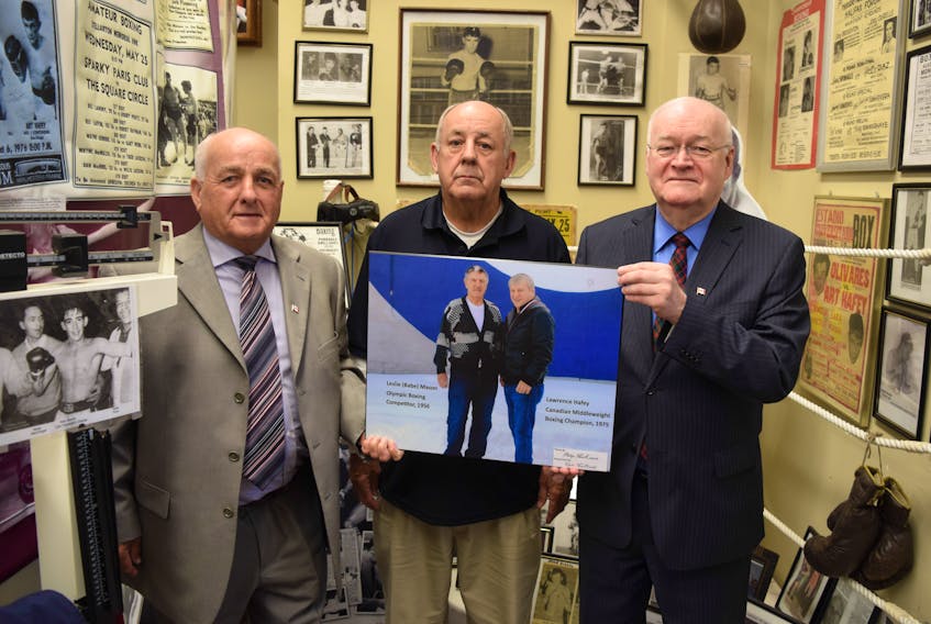 Philip MacKenzie, left and Clyde Macdonald, right, presented Barry Trenholm a plaque board photo of Lawrence Hafey and Babe Mason, two of Pictou County’s famed boxers.