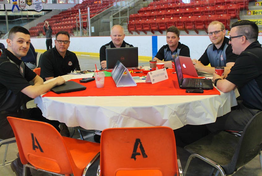 Staff from the Weeks Jr. A Crushers go over plans during the MHL draft held in Berwick June 9.