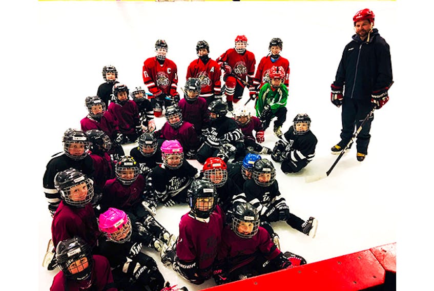 Ben Wallace, Cory MacGillivray, Ben Manos and Jax Graham of the Peewee AAA Crushers (shown in back) lent a hand to Faber Mackie’s IP5 team at the Stellarton rink on Dec. 9 as part of their participation in the Chevrolet Good Deeds Cup.