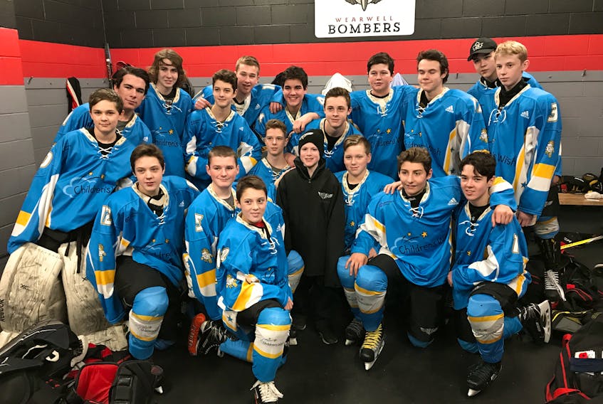 Oliver Smith, posing with the members of the Wearwell Bombers bantam team. Oliver, who is battle cancer, got his wish granted, and dropped the puck at their game against the Bedford Barons, on Saturday night.