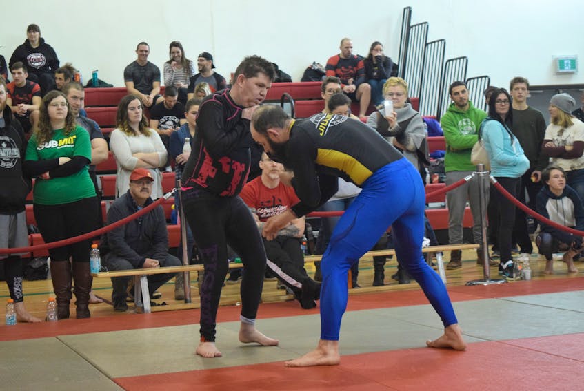 Adam Smith, a local practitioner of jiu jitsu (left) vies for the dominant position in a match on Sunday. Smith, who was looking to get a takedown at that moment in the match, was one of many local participants in the Nova Scotia Open Jiu Jitsu Championship, at New Glasgow Academy.