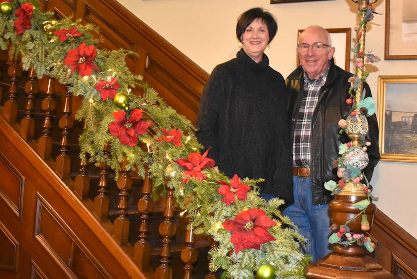 Susan MacIntosh and Barrie MacMillan stand on the stairs of the Carmichael-Stewart House Museum on Temperance Street in New Glasgow. The museum is being transformed for Christmas and the public is invited to stop by and see it.