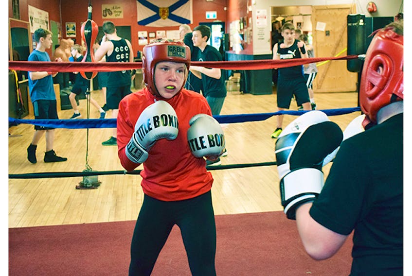 Sadie LeBlanc spars with Caden MacDonald recently at the Albion Amateur Boxing Club. The club is hosting a card on May 18.