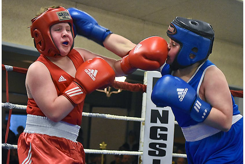 Caden MacDonald, left, of the Albion Amateur Boxing Cub, traded punches in a lively exhibition bout with Hunter Naugle of the Westville Boxing Club on May 18.