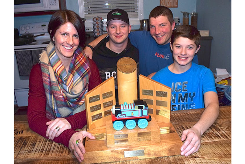 Kaitlin Graham and Jax Graham are shown with the Cancer Sucks Cup trophy, while in back are Isaac Koehoorn, left, and Drew Graham.