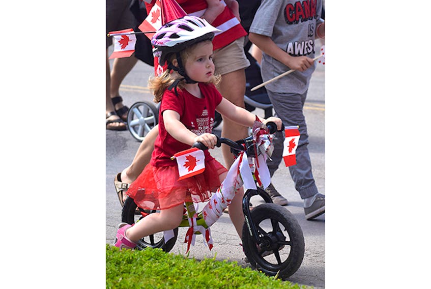 Paige Fraser kept her eyes on the street as she rode her bicycle during the children’s parade on June 29.