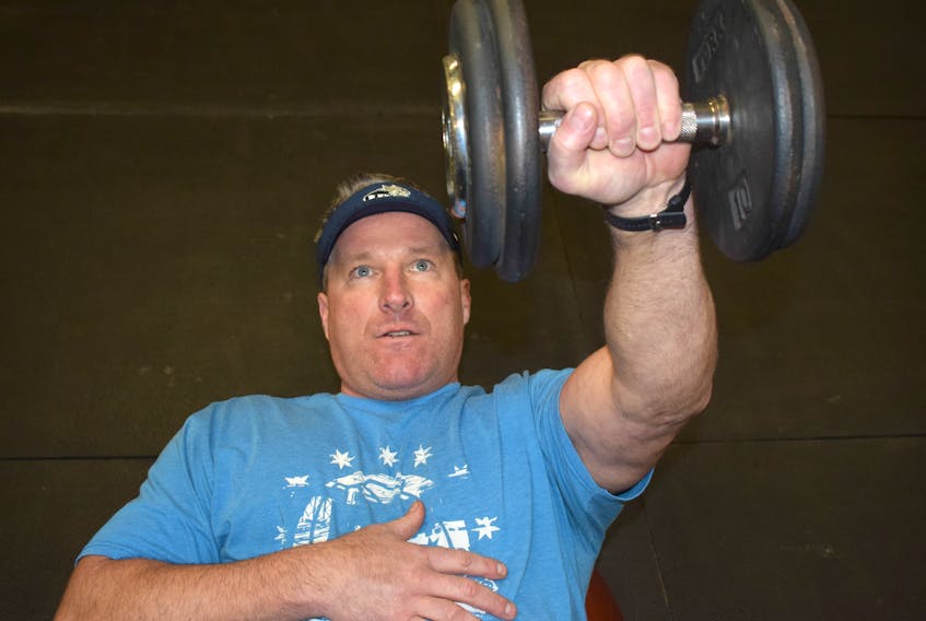 Dave MacIntyre lifts a 40-pound weight at his new performance and fitness centre on the Westville Road.
