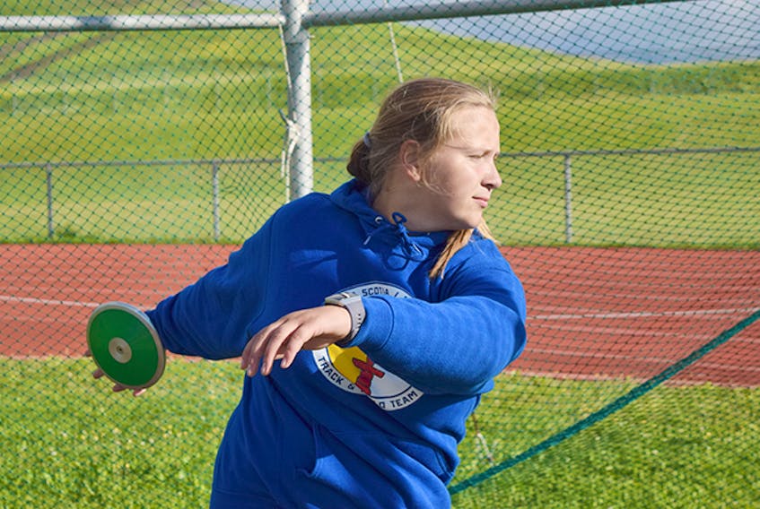 Thrower Keighan DeCoff in the cage at the Pioneer Coal Track and Field facility.